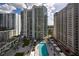 Inviting pool area with lounge seating and city backdrop at 450 Knights Run Ave # 407, Tampa, FL 33602