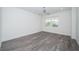 Spacious bedroom with large window and wood-look floors at 455 Pinellas Bayway S # 2A, Tierra Verde, FL 33715