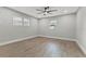 Spacious bedroom with wood-look flooring, a ceiling fan, and large windows at 623 15Th Nw Ave, Largo, FL 33770