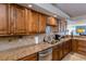 Modern kitchen featuring granite countertops and stainless steel appliances at 632 Edgewater Dr # 532, Dunedin, FL 34698