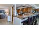 Modern kitchen featuring granite counters and wood cabinetry at 632 Edgewater Dr # 532, Dunedin, FL 34698