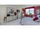 Comfortable bedroom with dresser, TV and ensuite bath at 632 Edgewater Dr # 532, Dunedin, FL 34698