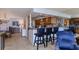 Bright kitchen with granite countertops, wood cabinets, and breakfast bar at 632 Edgewater Dr # 532, Dunedin, FL 34698