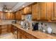 Well-equipped kitchen with granite countertops and wood cabinets at 632 Edgewater Dr # 532, Dunedin, FL 34698
