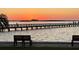 Peaceful waterfront view with benches and a sunset at 632 Edgewater Dr # 532, Dunedin, FL 34698
