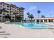 Inviting community pool with surrounding lounge chairs and building in background at 632 Edgewater Dr # 532, Dunedin, FL 34698