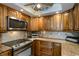 Kitchen boasts granite counters, stainless steel appliances, and wood cabinets at 632 Edgewater Dr # 532, Dunedin, FL 34698