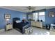 Guest bedroom with a twin bed, dresser, and ceiling fan at 632 Edgewater Dr # 532, Dunedin, FL 34698