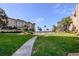 Landscaped lawn with walkway leading to pool and building at 632 Edgewater Dr # 532, Dunedin, FL 34698