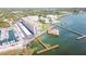 Aerial view showcasing waterfront property with boat slips and a community building at 632 Edgewater Dr # 532, Dunedin, FL 34698
