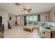 Living room with sectional sofa, ottoman, and a view of the entryway at 741 Windward Way, Palm Harbor, FL 34685