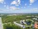 Aerial view of community, featuring buildings, lush landscaping, lake, and surrounding areas at 8198 Terrace Garden N Dr # 403, St Petersburg, FL 33709