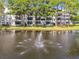 Aerial view of condo community with lake, fountain, and lush landscaping at 8198 Terrace Garden N Dr # 403, St Petersburg, FL 33709