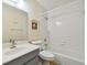 Clean bathroom with white tiled walls, bathtub, and gray vanity at 8198 Terrace Garden N Dr # 403, St Petersburg, FL 33709