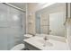 Bathroom with gray vanity, white sink, and shower with glass doors at 8198 Terrace Garden N Dr # 403, St Petersburg, FL 33709