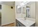 Bathroom with gray vanity, white countertop, and mirrored medicine cabinet at 8198 Terrace Garden N Dr # 403, St Petersburg, FL 33709