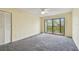 Bedroom featuring gray carpeting and a private balcony at 8198 Terrace Garden N Dr # 403, St Petersburg, FL 33709