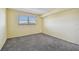 Bright bedroom with gray carpet and sliding glass door to balcony at 8198 Terrace Garden N Dr # 403, St Petersburg, FL 33709