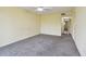 Spacious bedroom with gray carpeting and access to hallway at 8198 Terrace Garden N Dr # 403, St Petersburg, FL 33709