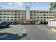 Condo building exterior with parking and landscaping at 8198 Terrace Garden N Dr # 403, St Petersburg, FL 33709