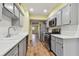 Modern kitchen with gray cabinets and stainless steel appliances at 8198 Terrace Garden N Dr # 403, St Petersburg, FL 33709