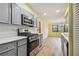 Gray cabinets, stainless steel appliances, and light wood flooring create a modern kitchen at 8198 Terrace Garden N Dr # 403, St Petersburg, FL 33709