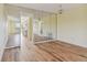 Living room with mirrored wall and wood floors at 8198 Terrace Garden N Dr # 403, St Petersburg, FL 33709