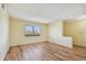 Bright living room with wood-look floors and large window at 8198 Terrace Garden N Dr # 403, St Petersburg, FL 33709