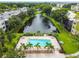 Community pool area with surrounding landscaping and lake view at 8198 Terrace Garden N Dr # 403, St Petersburg, FL 33709