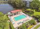 Aerial view of community pool with surrounding patio and lounge chairs at 8198 Terrace Garden N Dr # 403, St Petersburg, FL 33709