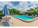 Community pool with lounge chairs and patio umbrellas at 8198 Terrace Garden N Dr # 403, St Petersburg, FL 33709