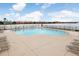 Resort-style community pool with lake view at 9328 Lake Chase Island Way # 9328, Tampa, FL 33626