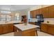Spacious kitchen with island, stainless steel appliances, and ample wood cabinetry at 11004 Carnes St, Weeki Wachee, FL 34613