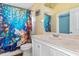 Bathroom with mermaid-themed shower curtain and single vanity at 11004 Carnes St, Weeki Wachee, FL 34613