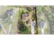 Aerial view of a house with a large yard and driveway at 11004 Carnes St, Weeki Wachee, FL 34613