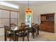 Charming dining room with wood table and chairs, and a Coca-Cola light fixture at 11004 Carnes St, Weeki Wachee, FL 34613