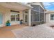 Enclosed patio area with brick pavers and potted plants at 11004 Carnes St, Weeki Wachee, FL 34613