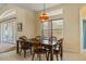 Bright dining area with wood table and chairs, near sliding glass doors at 11004 Carnes St, Weeki Wachee, FL 34613