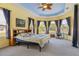 Spacious main bedroom with large windows, a ceiling fan, and a Starry Night painting at 11004 Carnes St, Weeki Wachee, FL 34613