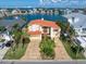 Waterfront home with terracotta roof and paved driveway at 18 Winston Dr, Belleair, FL 33756