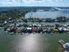 Aerial view of a waterfront neighborhood showcasing a variety of homes at 18 Winston Dr, Belleair, FL 33756