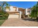 Two-story home with circular driveway and landscaping at 18 Winston Dr, Belleair, FL 33756