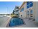 Inviting pool with brick patio and water views at 18 Winston Dr, Belleair, FL 33756