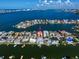 Aerial view of waterfront home with private dock and boat lift at 18 Winston Dr, Belleair, FL 33756