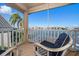 Relaxing balcony overlooking the water with comfortable seating at 18 Winston Dr, Belleair, FL 33756