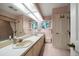 Bright bathroom with double sinks, a bathtub, and updated fixtures at 18 Winston Dr, Belleair, FL 33756