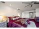 Main bedroom with red carpet, large bed, and access to en-suite bathroom at 18 Winston Dr, Belleair, FL 33756