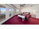 Spacious bedroom with deep red carpet and water views at 18 Winston Dr, Belleair, FL 33756