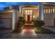 Eveneing view of home's entrance with brick path and landscaping at 18 Winston Dr, Belleair, FL 33756