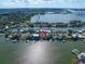 Aerial close-up view of a waterfront home with private dock and boat at 18 Winston Dr, Belleair, FL 33756
